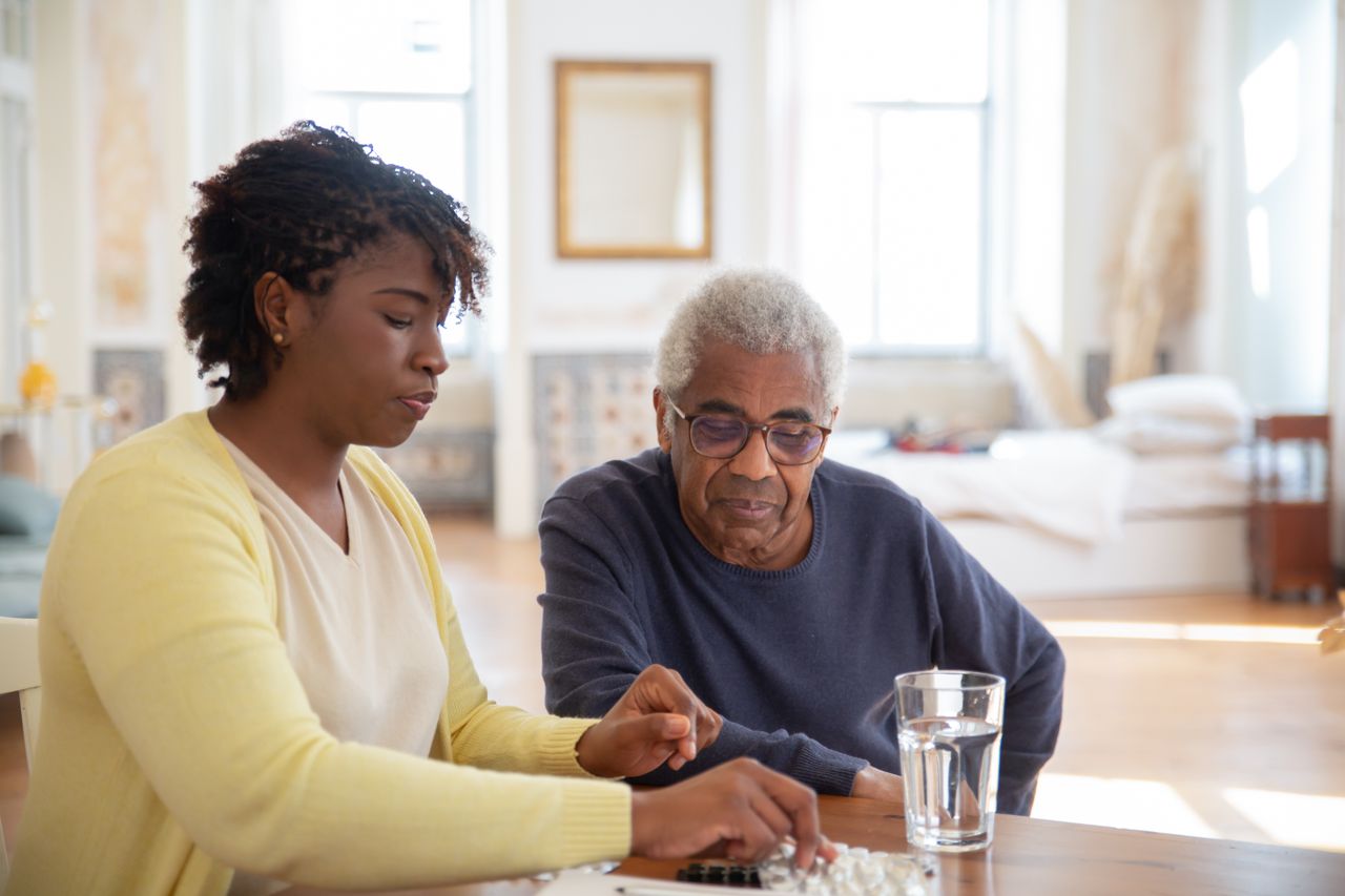 Crafting Captivating Headlines: Your awesome post title goes here Nurse helping senior man with his medication at home, ensuring health and safety.